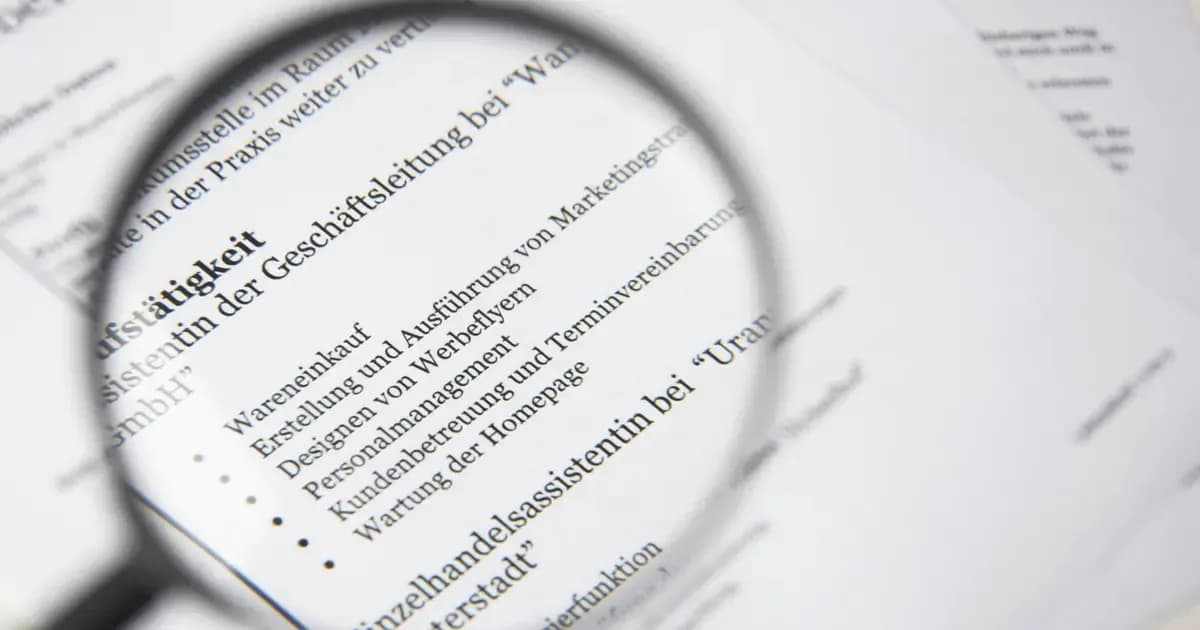 A magnifying glass positioned over a rental contract with a rent figure highlighted, representing a check for an illegal overcharge